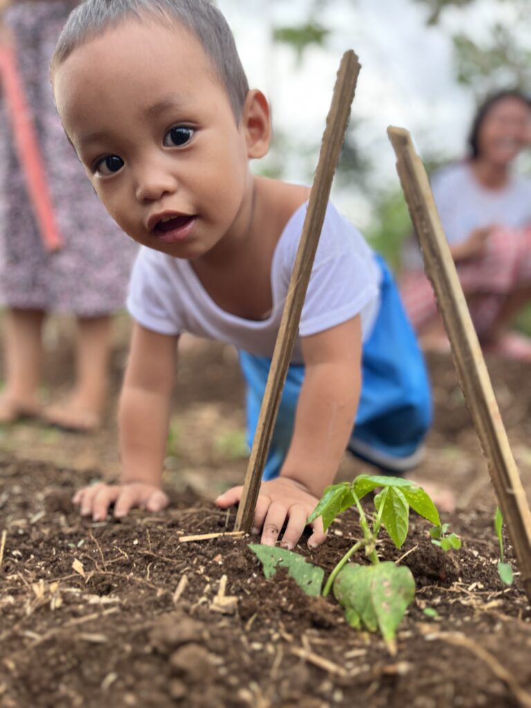 Empowering Mothers - One of the sons enjoying the gardening time with mom.
