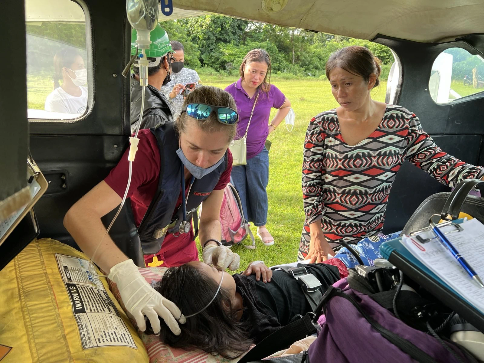 A PAMAS medical volunteer provides free medical care to a child in the Philippines.